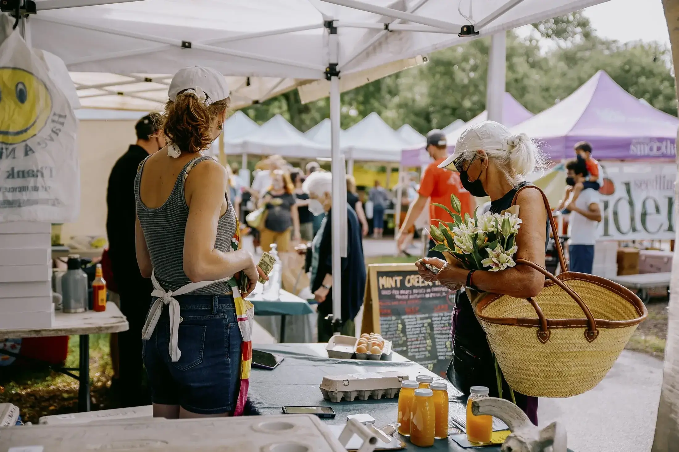 Market staff assisting customers at farmers’s market